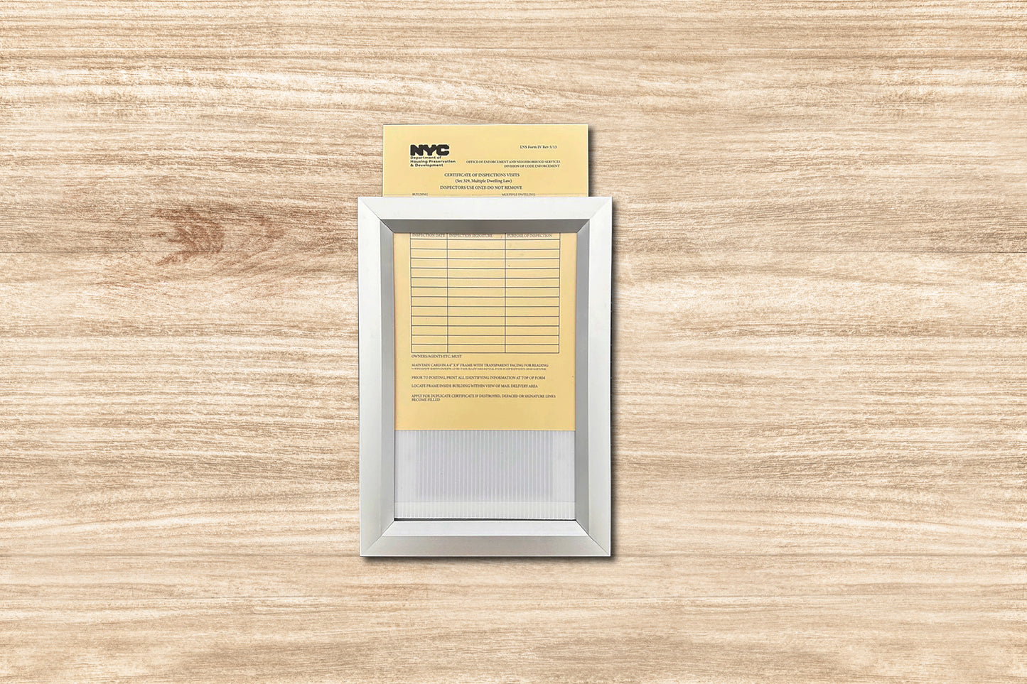 Small electronic device with a yellow card attached on a wooden surface