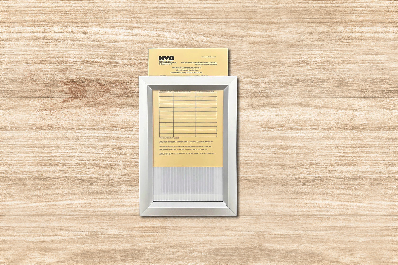 Small electronic device with a yellow card attached on a wooden surface