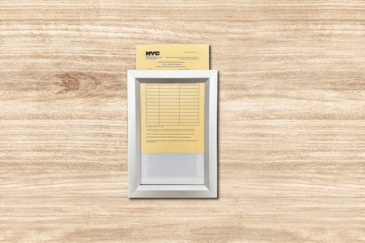 Small electronic device with a yellow card attached on a wooden surface